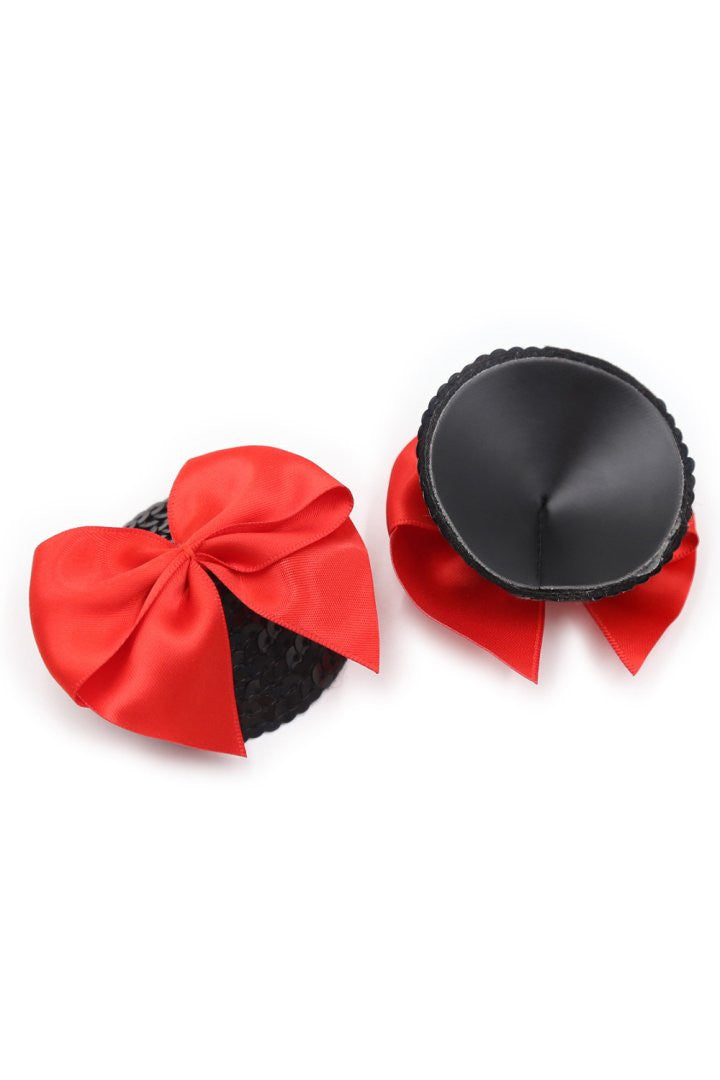 Paire de cache tétons adhésifs noir avec nœud papillon rouge